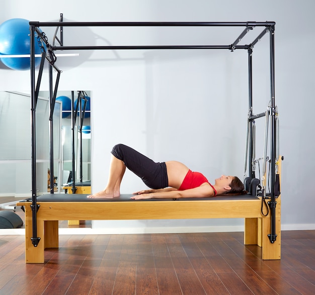 pregnant woman pilates reformer shoulder bridge