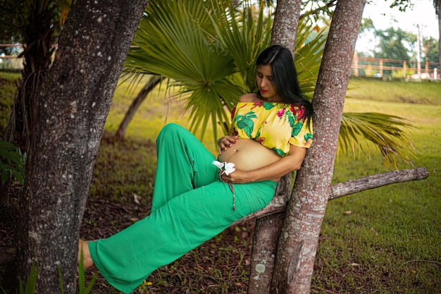 Pregnant woman posing in a park