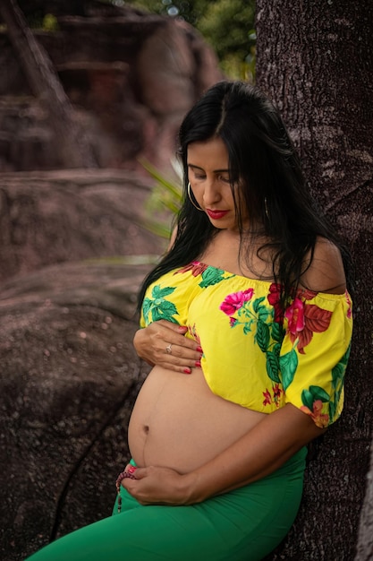 Pregnant woman posing in a park