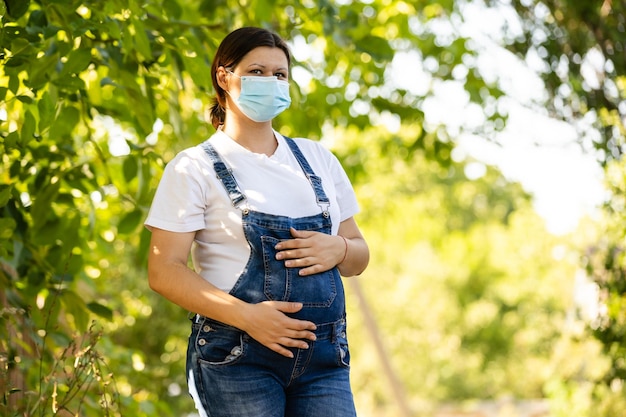 Pregnant woman in a protective mask