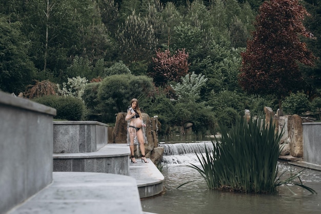 pregnant woman in a raincoat in the park