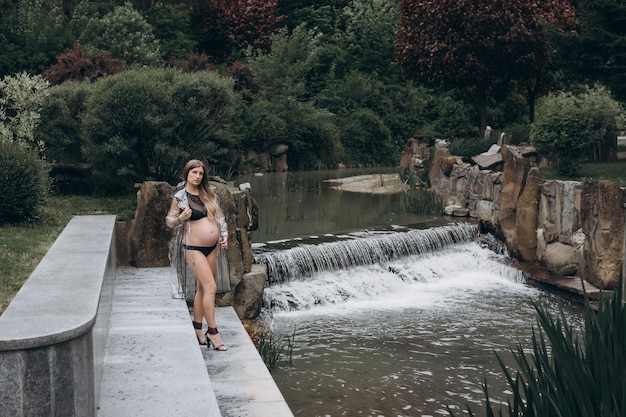 pregnant woman in a raincoat in the park