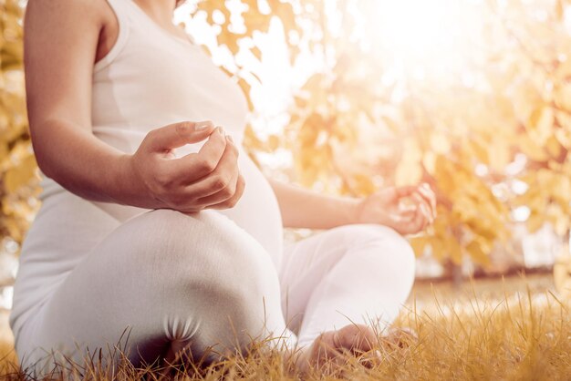 Pregnant woman relaxing in the park