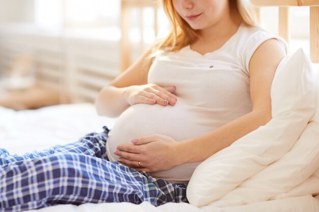 Carefree pregnant woman listening to music in city - a Royalty Free Stock  Photo from Photocase