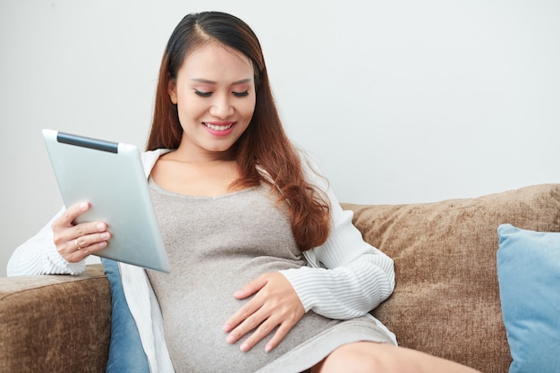 Pregnant woman resting on sofa