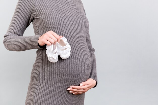 Pregnant woman showing her belly