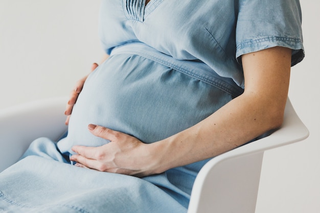 Pregnant woman sitting on chair