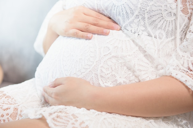 pregnant woman sitting on sofa close up