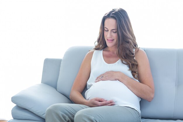 Pregnant woman sitting on sofa