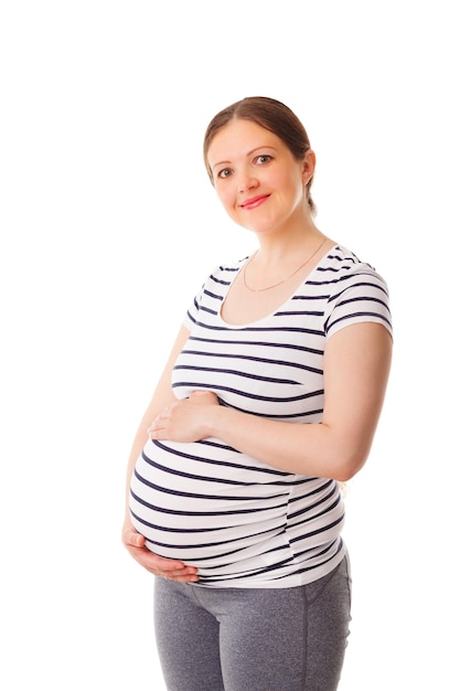 Pregnant woman standing embracing her belly