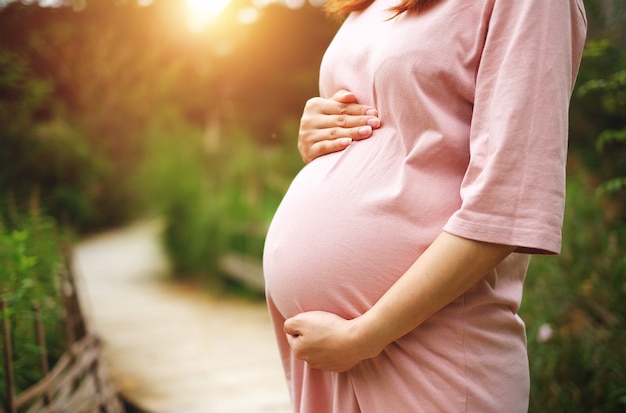 Pregnant woman standing on a walkway