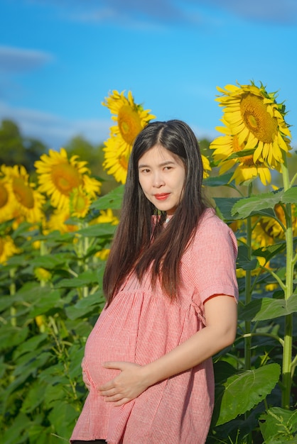 Pregnant woman in a sunflower field