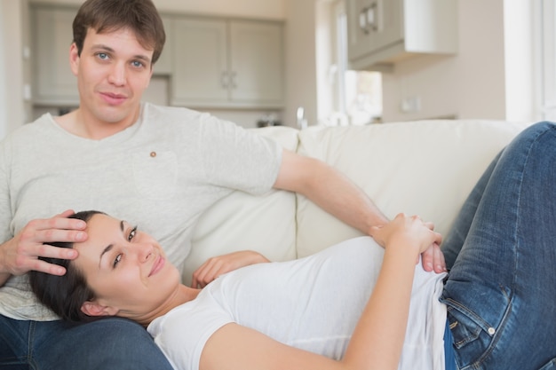 Photo pregnant woman touching her belly with husband