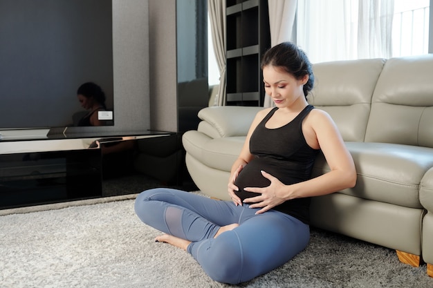 Pregnant woman touching her belly