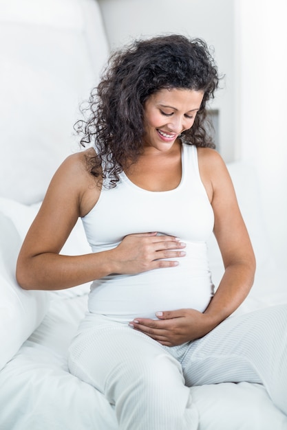 Pregnant woman touching tummy