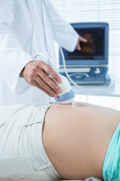 Pregnant woman undergoing ultrasound test in hospital