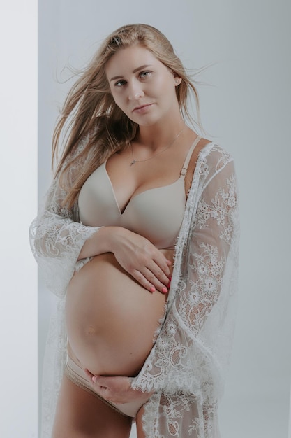 Pregnant woman in underwear. Studio shot