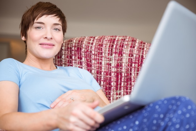 Pregnant woman using her laptop