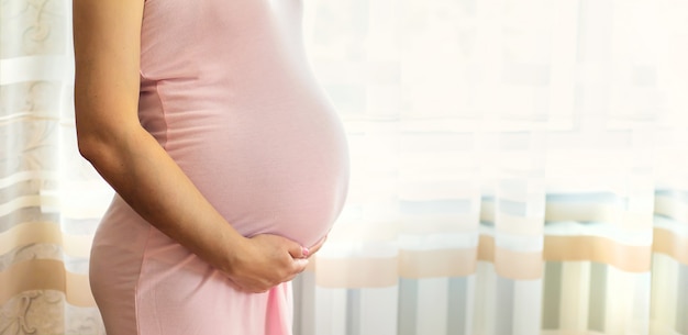 Pregnant woman wearing a pink dress