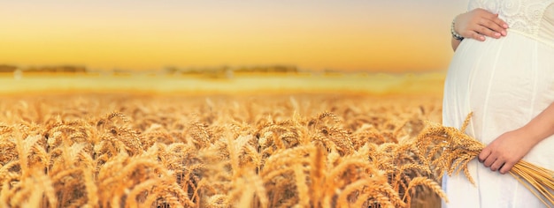 Pregnant woman in a wheat field Selective focus