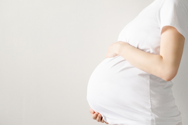 Pregnant woman in a white tee shirt