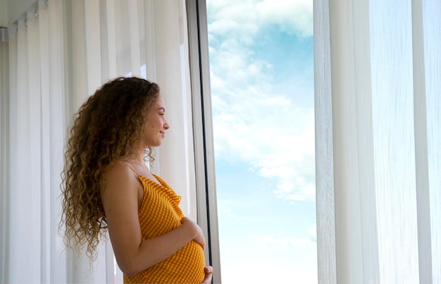 pregnant woman at window