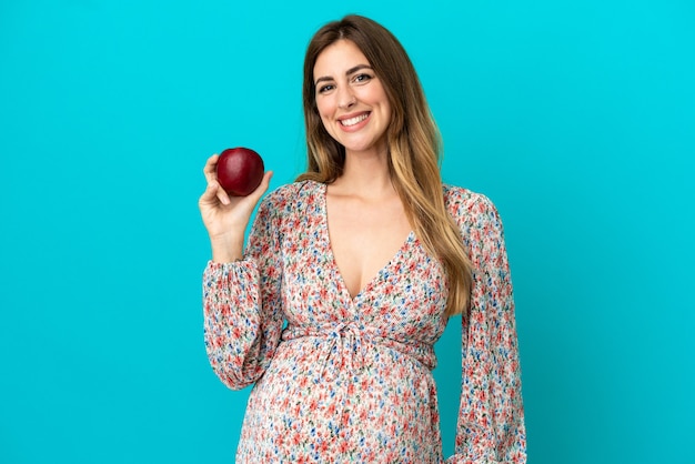 Pregnant woman with an apple and happy