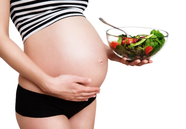 Pregnant woman with a bowl of vegetables