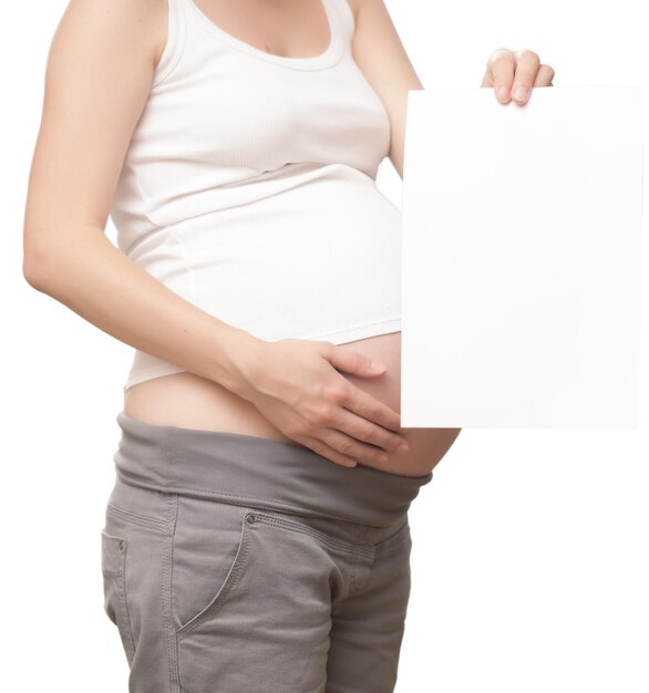 The pregnant woman with a clean sheet of paper for text