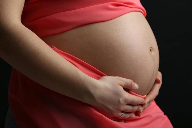 Pregnant woman with coral material close up