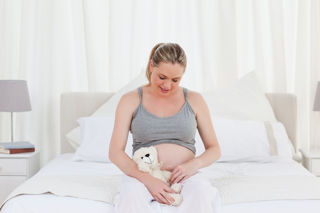 Pregnant woman with a cuddly toy