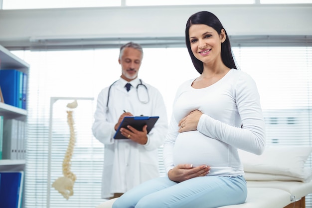 Pregnant woman with doctor in clinic