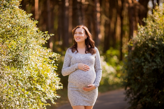 pregnant woman with dress posing in nature