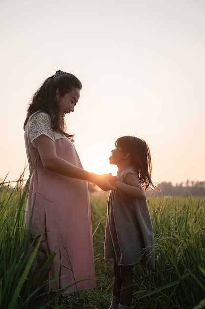 Pregnant woman with her daughter enjoying outdoor