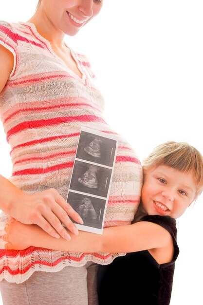 Pregnant woman with her daughter on a white background with ultrasound