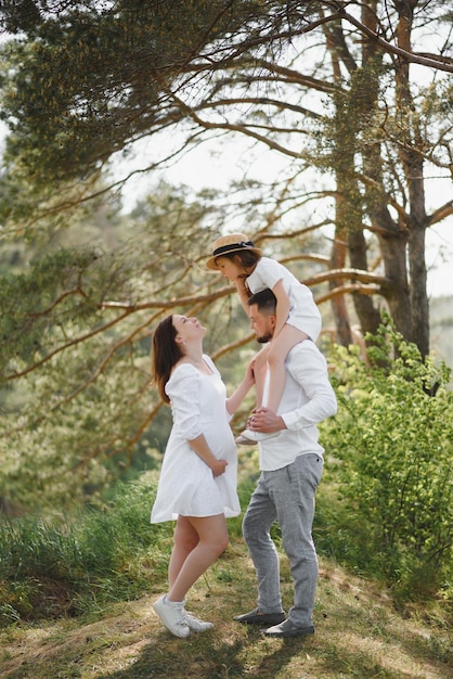 Pregnant woman with her family looking happy