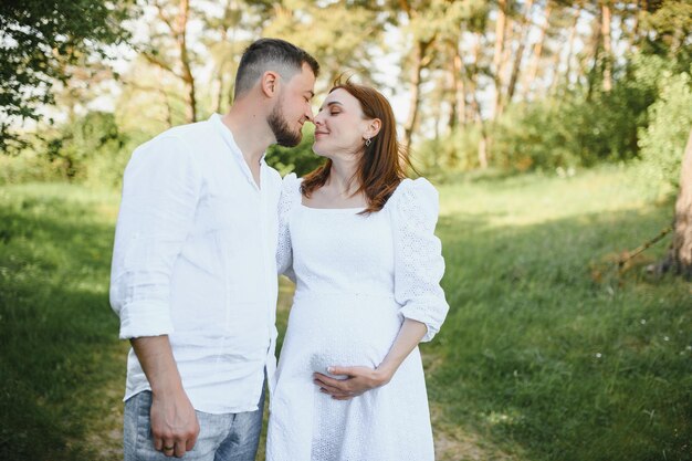 Pregnant woman with her family looking happy