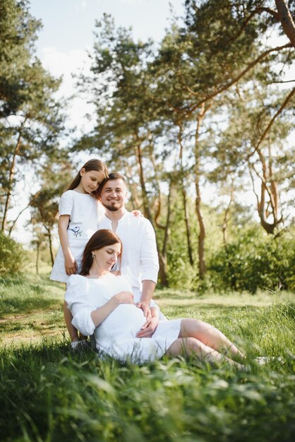 Pregnant woman with her family looking happy