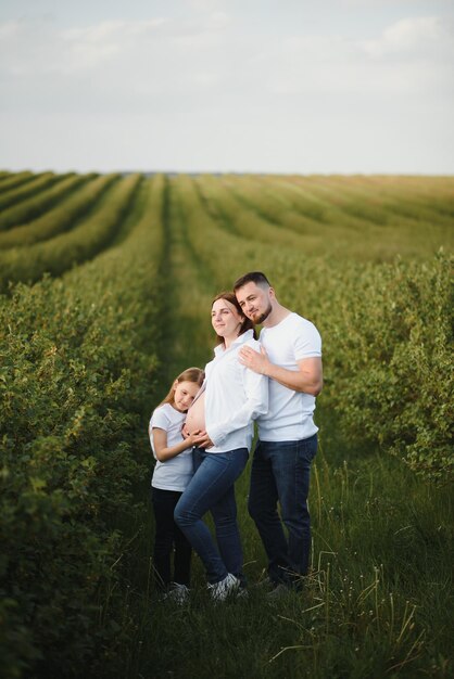 Pregnant woman with her family looking happy