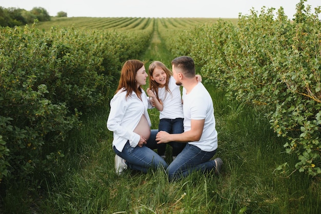 Pregnant woman with her family looking happy