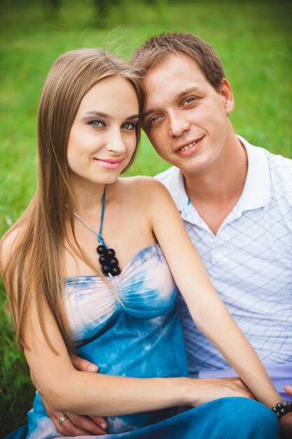 Pregnant woman with her husband in the park.