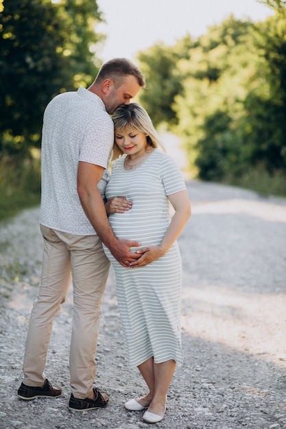 Pregnant woman with her husband in park