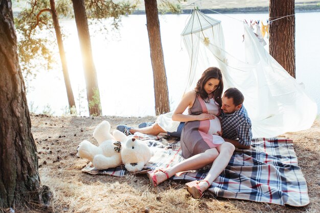 Pregnant woman with her husband at  picnic