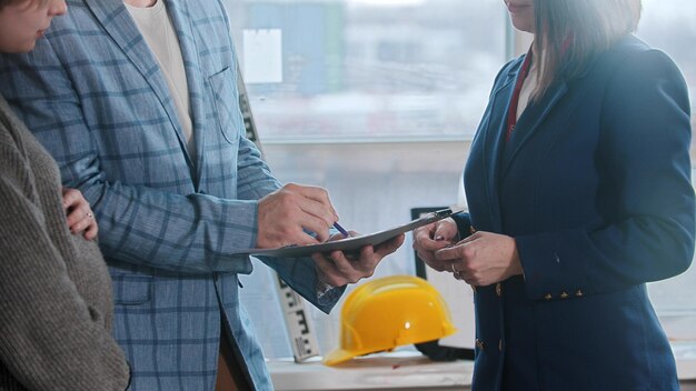 A pregnant woman with her husband signing papers for the apartment rental