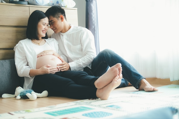 Pregnant woman with husband at home