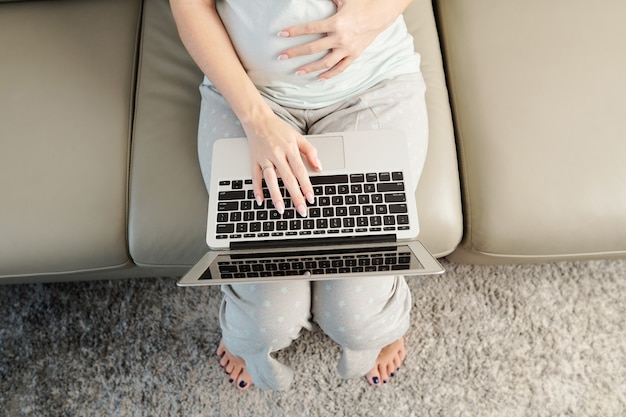 Pregnant woman with laptop