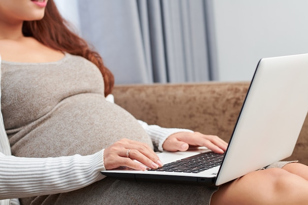 Pregnant woman with laptop