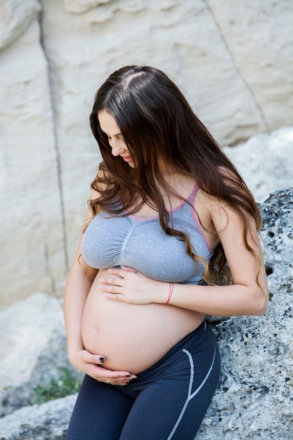 Pregnant woman with long healthy hair outdoor