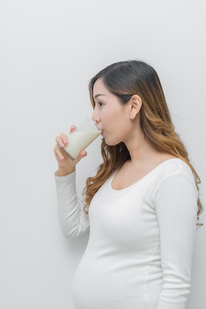 Pregnant woman with milk in her handDrinking milk is good health to the pregnancy