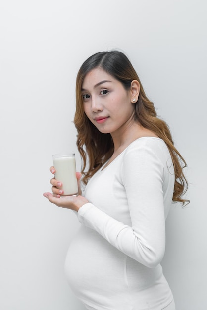 Pregnant woman with milk in her handDrinking milk is good health to the pregnancy